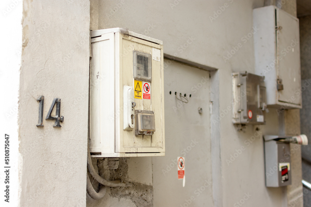 Residential natural gas meter locked in a white box for resources consumption at the exterior wall of an industrial construction