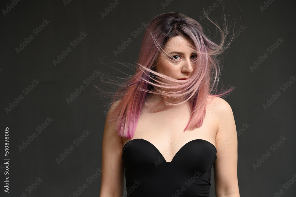 Fototapeta premium Portrait of a caucasian model with curly hair looking at the camera
