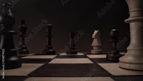 Playing Chess: Chessboard with White Bishop Passing the Camera and Black Rook Moving Vertically in Slow Motion - View from Pawn's Perspective
