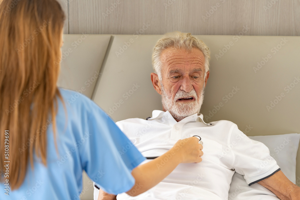 Man being cared for by a private Asian nurse at home suffering from Alzheimer's disease to closely care for elderly patients Man being cared for by a private Asian nurse at home suffering from Alzheimer's disease to closely care for elderly patients