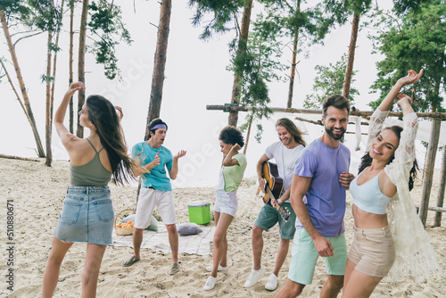 Portrait of attractive cheerful friends friendship dancing enjoying having fun carefree entertainment at beach picnic outdoors