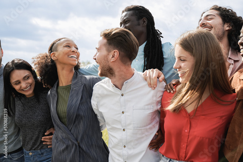 Multiethnic group of friends having fun together outdoor - Millenial friends laughing together outside