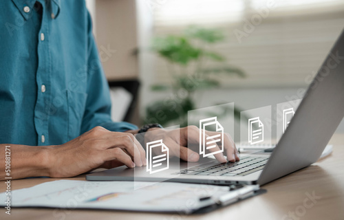 businessman sitting on a computer monitor document management concept with icons on virtual ERP screens.