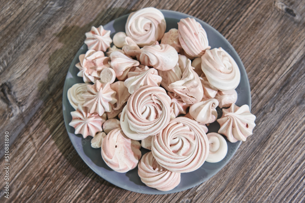 pink with white meringue on a plate close-up top view