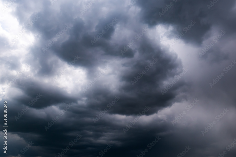 Beautiful thunderclouds. Beautiful dramatic blue sky background with fluffy dark clouds. Rainy weather.