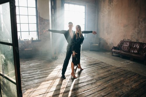 Print op canvas Couple of two professional ballroom dancers is dancing on loft studio