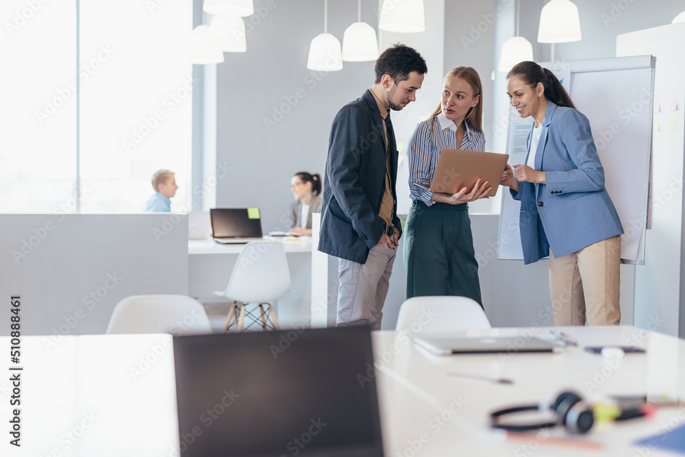 Woman discussing data with colleagues in a meeting. Woman discussing data with colleagues in a meeting.