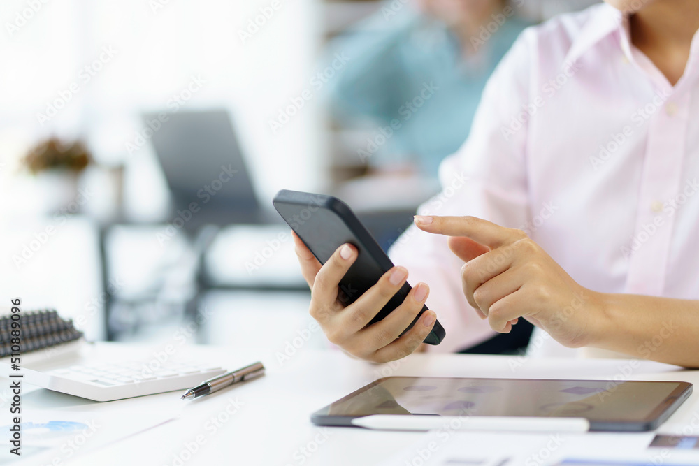 Fototapeta premium Closeup image of female using smartphone to send text , work or play social media.