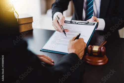 Fotografie, Tablou male lawyer pointed to a legal document explaining the terms of a consultation with a business woman