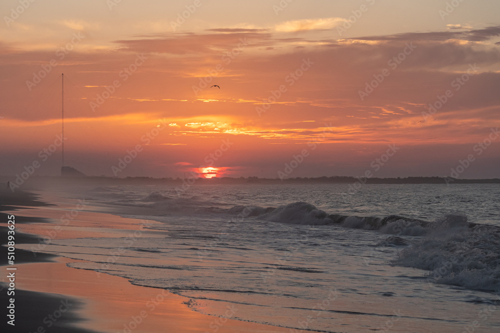 Ocean waves at sunrise off the shore of Cape May , New Jersey USA