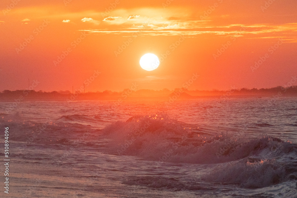 Ocean waves at sunrise off the shore of Cape May , New Jersey USA
