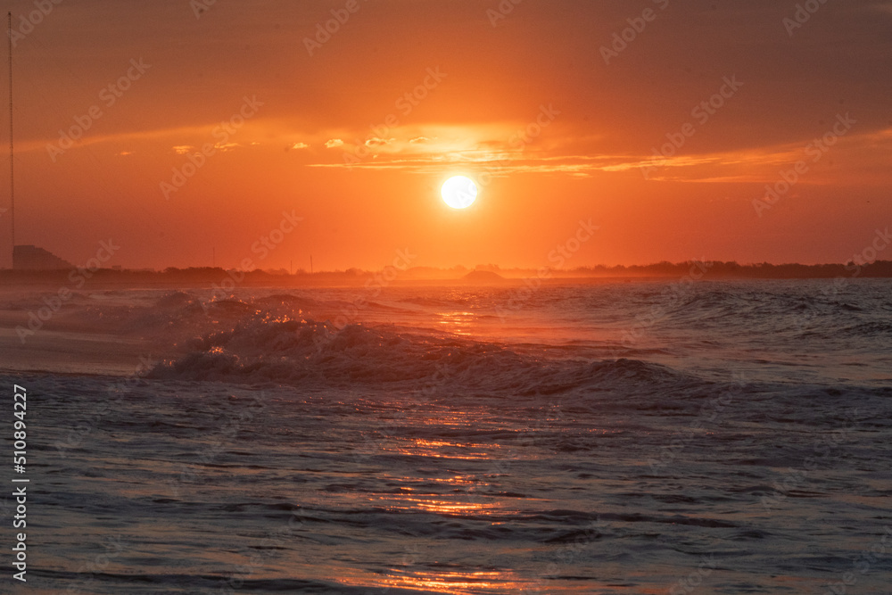 Ocean waves at sunrise off the shore of Cape May , New Jersey USA