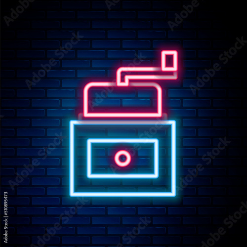 Glowing neon line Manual coffee grinder icon isolated on brick wall background. Colorful outline concept. Vector