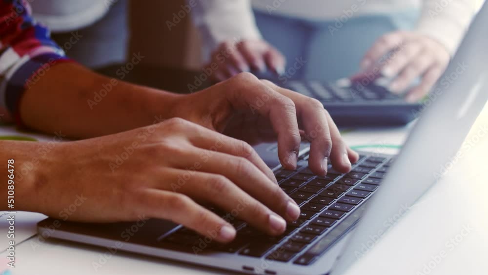 Hands of office workers typing on laptop keyboard and the hands of a woman with a calculator and stickers, close-up. The concept assistance Hands of office workers typing on laptop keyboard and the hands of a woman with a calculator and stickers, close-up. The concept assistance