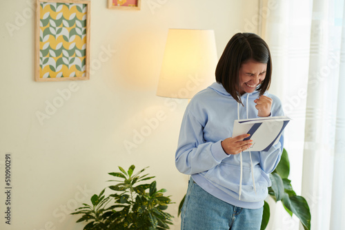 Tableau sur toile Excited girl making fist pump gesture after receiving acceptance letter from uni