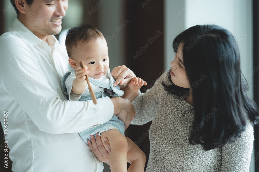 young Asian family are happy together at home by life insurance concept, child baby and mother and father having fun and smile with love, childhood living in cozy lifestyle with dad and mom young Asian family are happy together at home by life insurance concept, child baby and mother and father having fun and smile with love, childhood living in cozy lifestyle with dad and mom