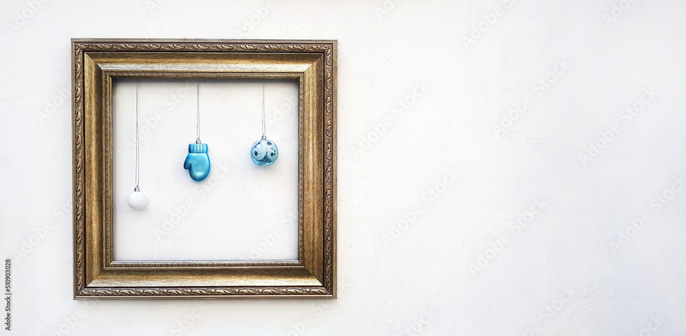 Empty colorful picture frame mockup with blue ball and light bulb hanging on white concrete wall with copy space for add or fill text. Framework on background. Decorate for festival, Celebrate party. Empty colorful picture frame mockup with blue ball and light bulb hanging on white concrete wall with copy space for add or fill text. Framework on background. Decorate for festival, Celebrate party.