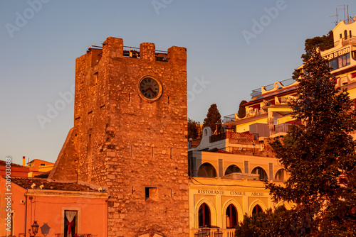First morning sun beams on San Giuseppe church on square Piazza IX Aprile at sunrise in Taormina, Province of Messina, Sicily, Italy, Europe, EU. St. Augustine Church, Corso Umberto during golden hour