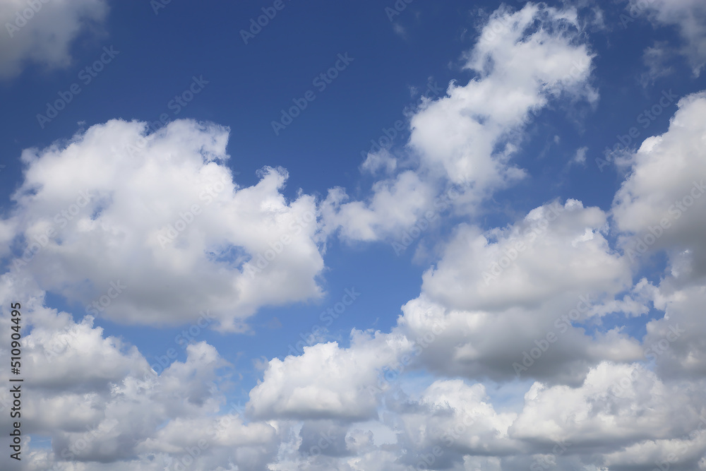 Isolated blue summer sky cloudscape photo with white fluffy fair weather cumulus clouds Isolated blue summer sky cloudscape photo with white fluffy fair weather cumulus clouds