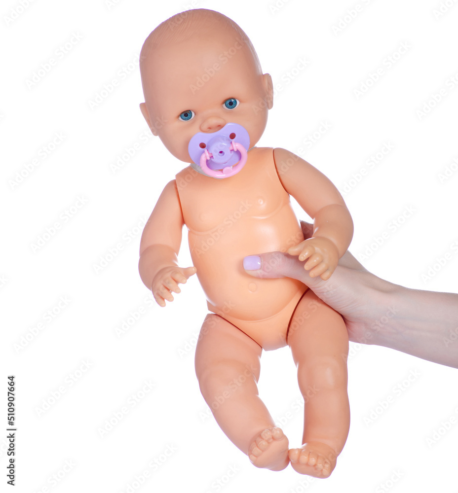Baby doll newborn in hand on white background isolation Baby doll newborn in hand on white background isolation