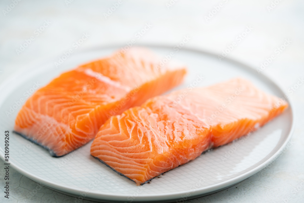 Fresh salmon fillet on a plate for delicious salmon steak. Fresh salmon fillet on a plate for delicious salmon steak.