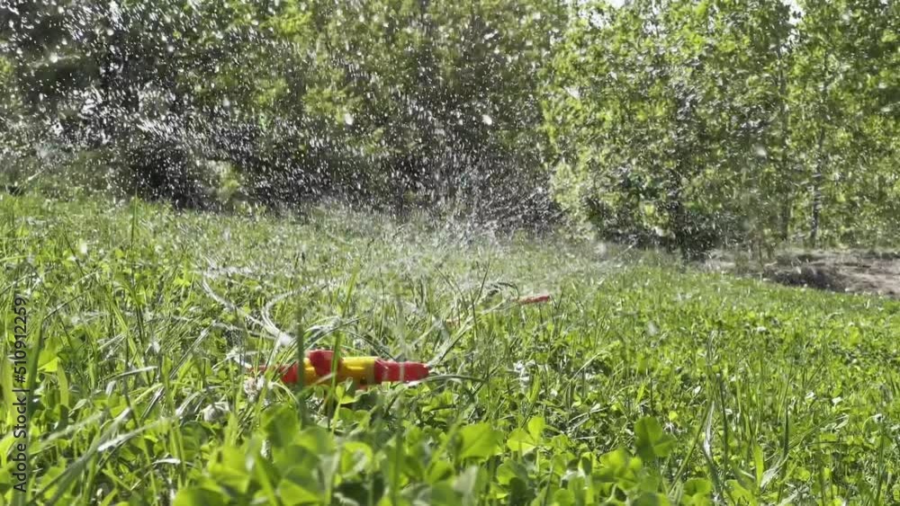 Landscape automatic garden watering system with rotating sprinklers installed on the lawn. Sprinkling. Gardening concept. Landscape automatic garden watering system with rotating sprinklers installed on the lawn. Sprinkling. Gardening concept.