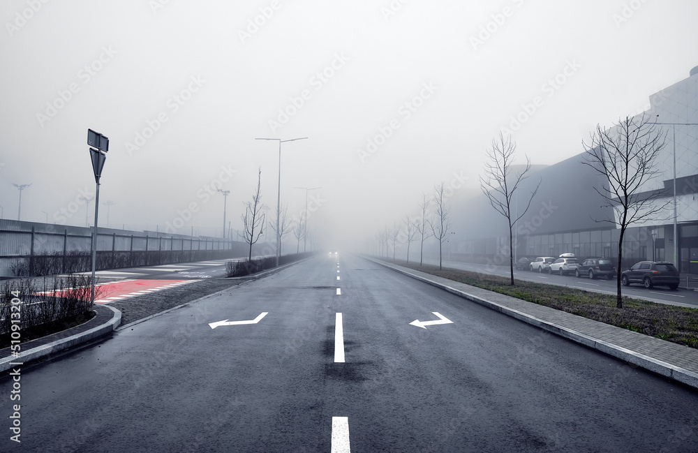 Asphalt road in the fog in the city. Asphalt road in the fog in the city.