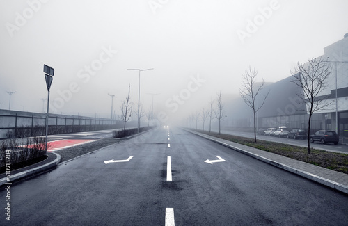 Asphalt road in the fog in the city.