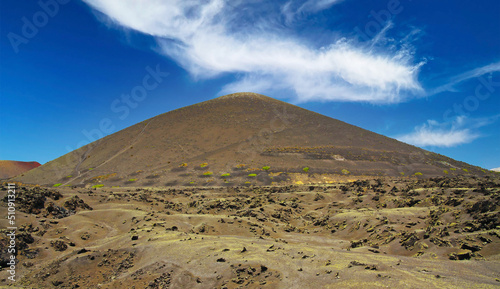 Monotone vulcanic landscape  lava ash sand field  volcano cone  clear blue sky - Timanfaya NP  Lanzarote