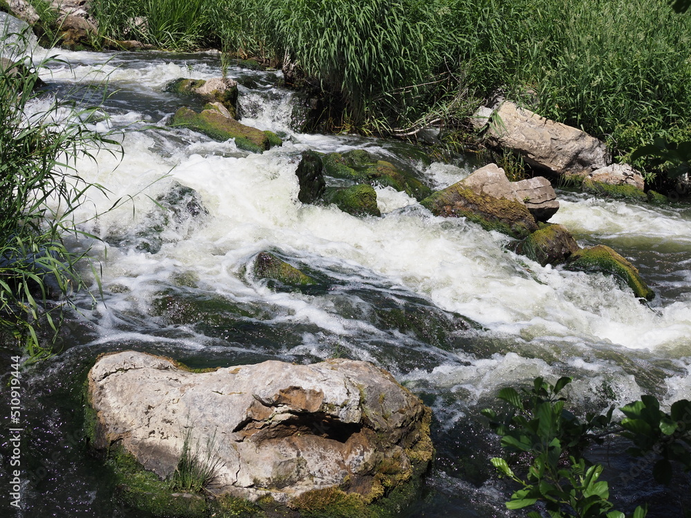 Mountain rever. Motion cascading green waterfall Mountain rever. Motion cascading green waterfall