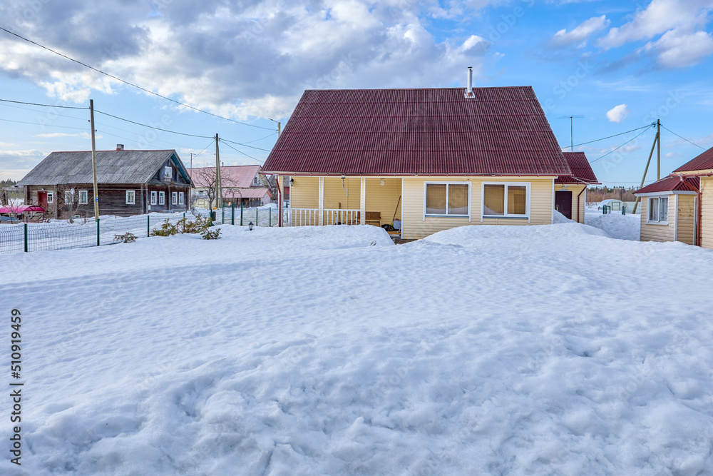 Snow-covered lawn in front of residential building in countryside. Snow-covered lawn in front of residential building in countryside.