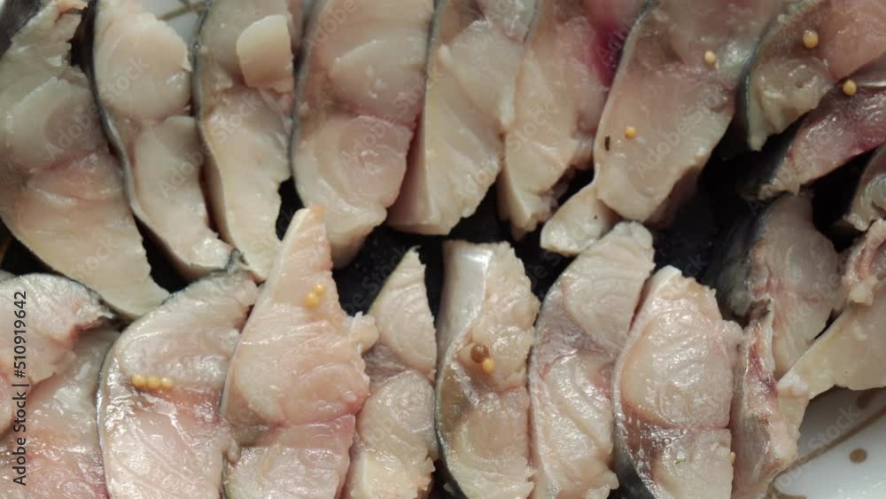 Pieces of marinated fish lie on a plate, top view. High quality 4k footage Pieces of marinated fish lie on a plate, top view. High quality 4k footage