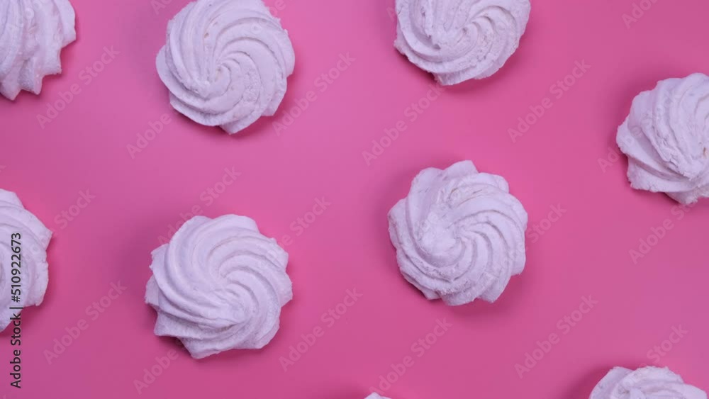 Rotating background of marshmallows or cakes, birthday cakes on a pink background. The concept of celebrating a party, anniversary in pink colors Rotating background of marshmallows or cakes, birthday cakes on a pink background. The concept of celebrating a party, anniversary in pink colors