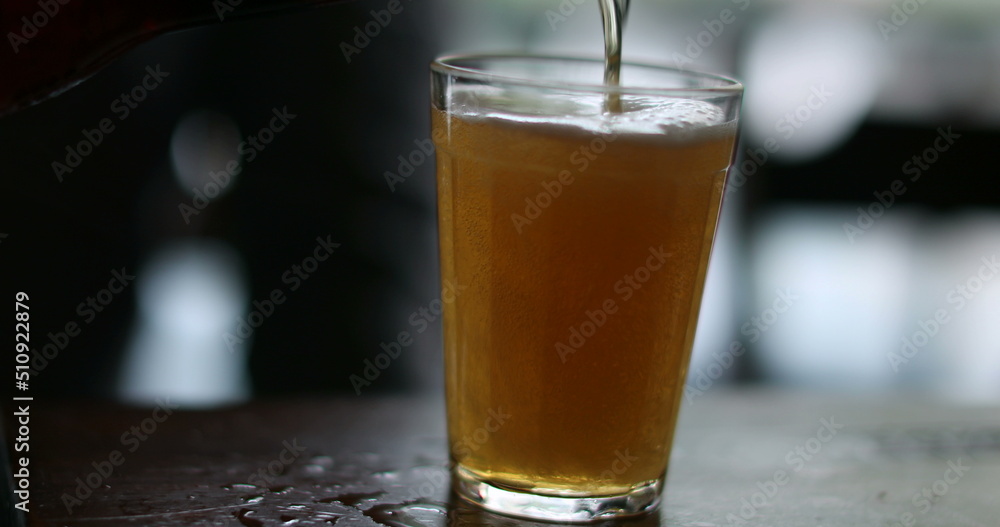 Person pouring beer into glass close-up, person serving alcoholic beverage and drinking Person pouring beer into glass close-up, person serving alcoholic beverage and drinking