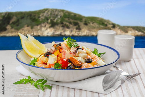 Fototapeta Naklejka Na Ścianę i Meble -  Dinner Table with mediteranina sea food near the sea shore.