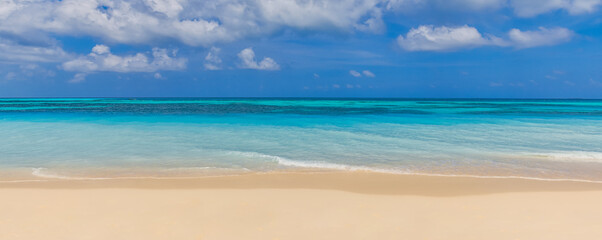 Closeup sand beach sea waves and blue summer sky. Panoramic beach landscape. Empty tropical beach and seascape, horizon. Bright exotic coast calmness, tranquil seaside nature view relaxing sunlight