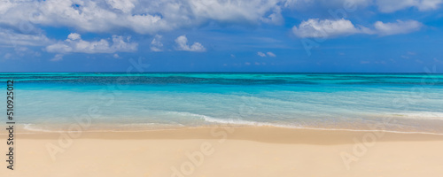 Closeup sand beach sea waves and blue summer sky. Panoramic beach landscape. Empty tropical beach and seascape, horizon. Bright exotic coast calmness, tranquil seaside nature view relaxing sunlight photo