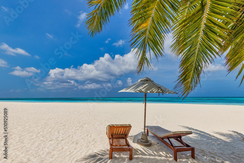 Summer vacation beach  travel scenic. Closeup couple chairs umbrella under palm trees  leaves. Sea sand sky  idyllic recreational landscape. Sunny beautiful tropical island landscape. Amazing paradise