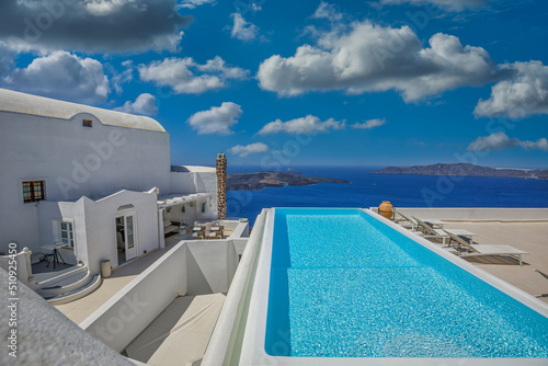 Luxury summer travel and vacation landscape. Swimming pool with sea view. White architecture on Santorini island, Greece. Beautiful resort terrace, famous destination scenic. Idyllic couple relaxation © icemanphotos