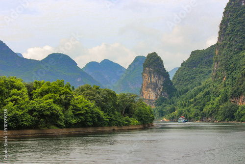 landscape photography of the li river in the guilin region of china with mountains in the background