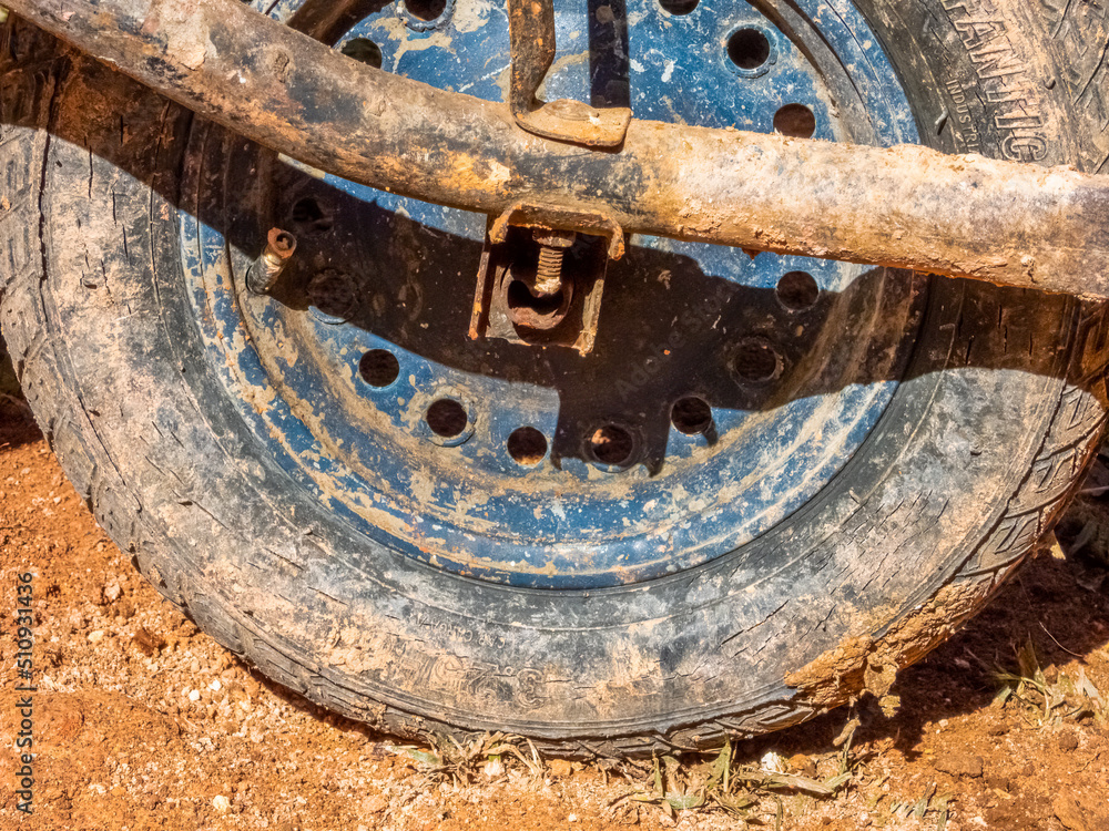 Monte Verde, Minas gerais, Brazil - June13 2022: very dirty and rusty wheel of a wheelbarrow. Field work. Monte Verde, Minas gerais, Brazil - June13 2022: very dirty and rusty wheel of a wheelbarrow. Field work.