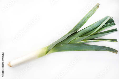 A leek on a white background. Green spring vegetables, isolated. Packshot photo, horizontal view with a copy space.