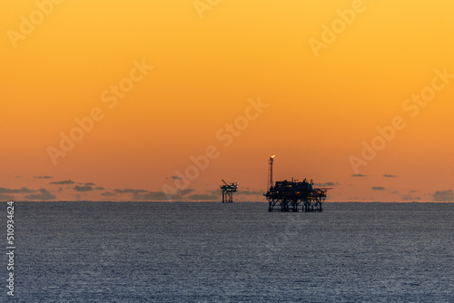 Offshore Drilling Platforms during Sunset in the Gulf of Mexico