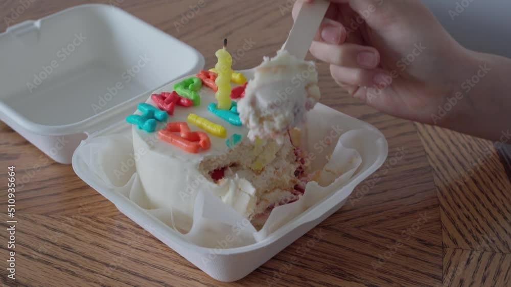 Hand of a teenager girl takes piece asian bento cake box with a wooden fork and happy bithday inscription. Delicious beautiful dessert. Small korean bento cake gift holiday. Korean style one person. Hand of a teenager girl takes piece asian bento cake box with a wooden fork and happy bithday inscription. Delicious beautiful dessert. Small korean bento cake gift holiday. Korean style one person.