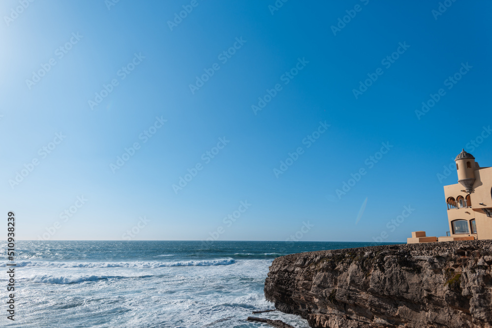 Beautiful views of the ocean with the mountain and the hotel lodge. House on a hill by the sea. Holidays in Portugal