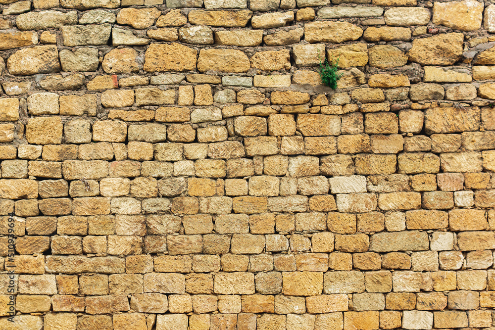 background, texture - a wall of rough blocks, with cracks between stones