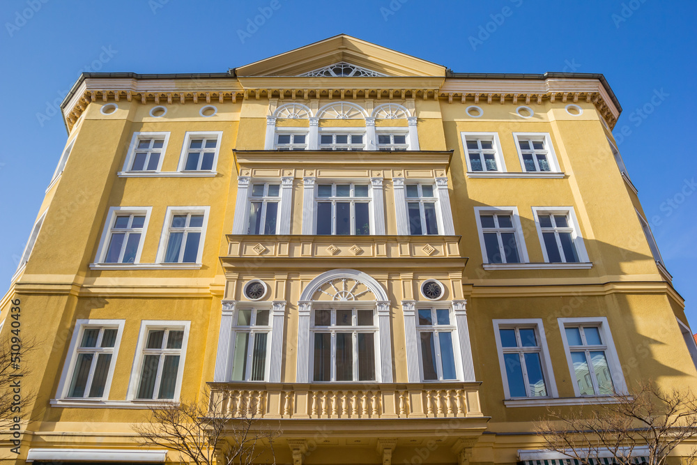 Colorful yellow facade of a historic building in Aschersleben, Germany