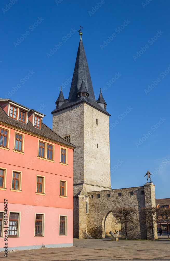 Pink house and historic city gate in Aschersleben, Germany