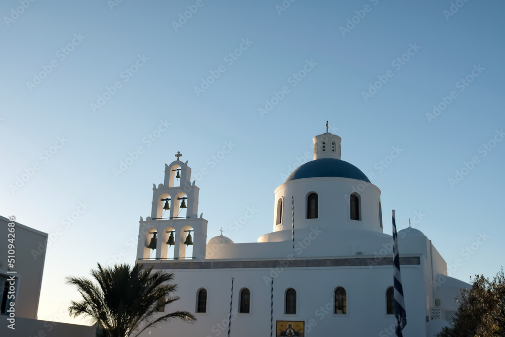 A beautiful white Orthodox Church and a blue sky in Oia Santorini Greece A beautiful white Orthodox Church and a blue sky in Oia Santorini Greece