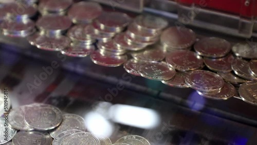 Coin pusher machines with a lot of coins photo